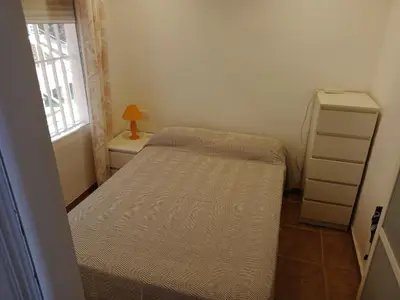 a small bedroom with a bed and a dresser at HAWAI, Esc-2, 3-10 in Cullera