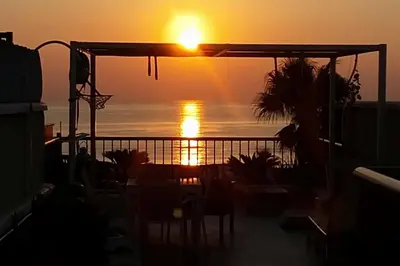 a sunset from the balcony of a house at Patacona Sunrises Premium in Valencia