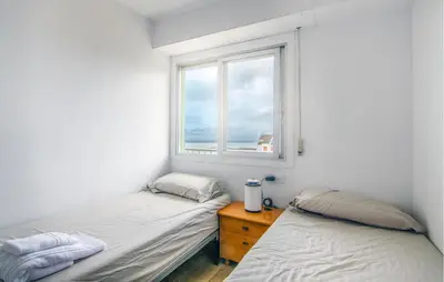 two beds in a room with a window at Beautiful Apartment In Cullera in Cullera