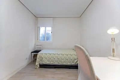 a white room with a bed and a window at Acogedor apartamento en Valencia cerca de la playa in Valencia