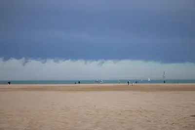 a group of people walking on the beach at Precioso apartamento en Malvarrosa Playa Valencia in Valencia