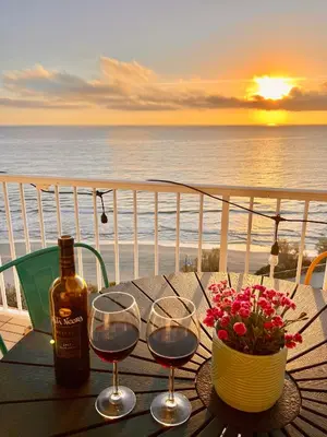 a table with two glasses of wine and a bottle at El Bikini Cullera - Junto a la playa - Right on the beach in Cullera