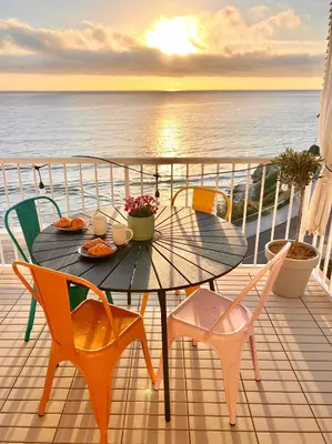 a table and chairs on a balcony with the ocean at El Bikini Cullera - Junto a la playa - Right on the beach in Cullera