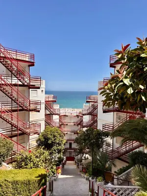 a building with red stairs and the ocean in the background at El Bikini Cullera - Junto a la playa - Right on the beach in Cullera