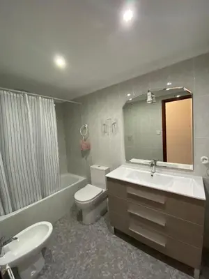 a bathroom with a sink toilet and a mirror at Gabriella Apartment Near the beach in Puerto de Sagunto