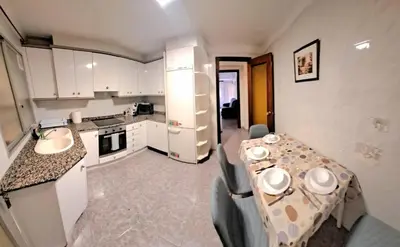 a kitchen with a table and chairs in a room at Gabriella Apartment Near the beach in Puerto de Sagunto