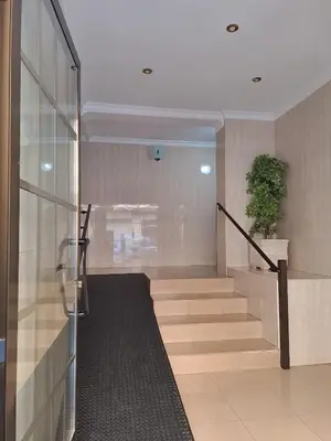 a lobby with a staircase with a potted plant at Gabriella Apartment Near the beach in Puerto de Sagunto