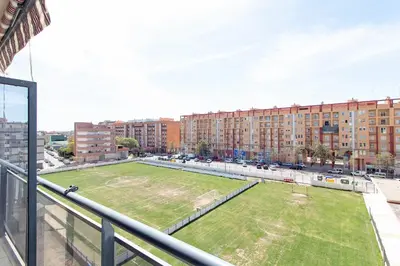 a large grassy field in a city with buildings at Global Vacacional, Bonito apartamento en Puerto Sagunto para parejas in Puerto de Sagunto