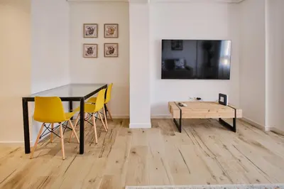 a dining room with a table and yellow chairs at Carmen flat in Valencia