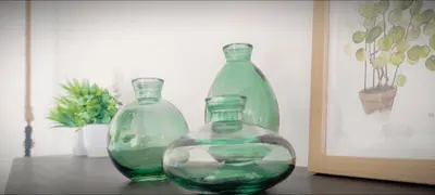 two green glass vases sitting on a table at Apartamento en la montaña, Serra in Serra