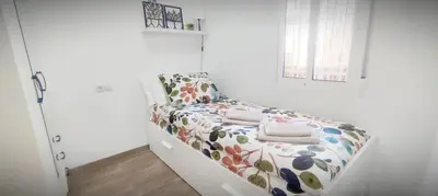 a white room with a bed in a room at Apartamento en la montaña, Serra in Serra