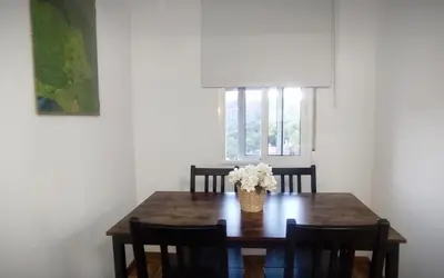 a dining room table with a vase of flowers on it at Apartamento en la montaña, Serra in Serra
