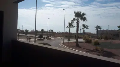 a view of a street with palm trees and a road at Neo Mediterráneo in Barrio-Mar