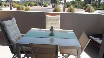a blue table and chairs on a balcony with a view at Neo Mediterráneo in Barrio-Mar