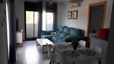 a living room with a blue couch and a table at Neo Mediterráneo in Barrio-Mar
