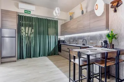 a kitchen with a table and a green shower curtain at Casa Maravillosa in Valencia