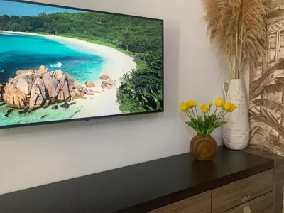 a tv hanging on a wall above a dresser at Casa Maravillosa in Valencia