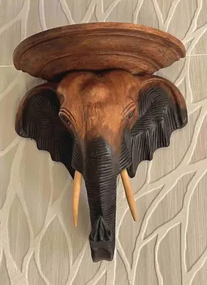a wooden elephant head hanging on a wall at Casa Maravillosa in Valencia