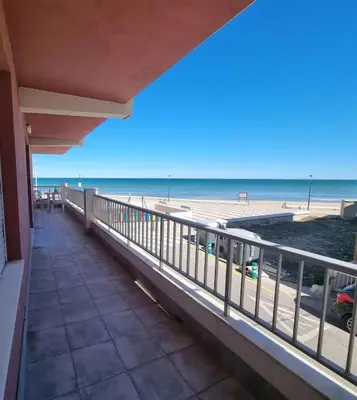 a balcony with a view of the beach at Apartamento en primera línea, Les Palmeretes in Sueca
