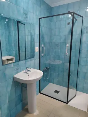 a bathroom with a sink and a glass shower at Casa de pueblo grande para 7 personas in Corbera de Alcira