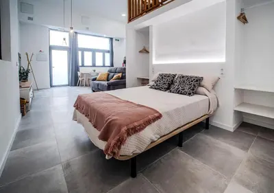 a living room with a couch and a kitchen at AROMA DE VALENCIA II cozy studio with loft in Valencia