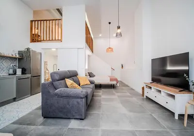 a living room with a couch and a ceiling at AROMA DE VALENCIA II cozy studio with loft in Valencia