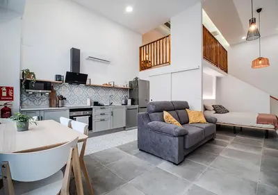 a bedroom with a bed and a living room at AROMA DE VALENCIA II cozy studio with loft in Valencia