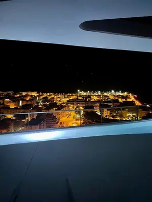 a view of a city at night from an airplane at Apartment Gran Canet by GRENT in Canet de Berenguer