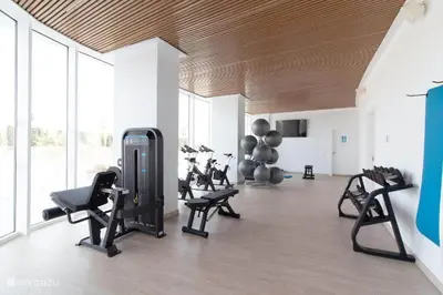 a gym with several exercise equipment in a room at Apartment Gran Canet by GRENT in Canet de Berenguer