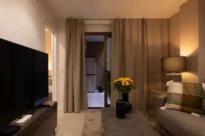 a living room with a television and a couch and a vase of flowers at Dorm4You Centro in Valencia