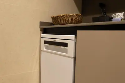 a small white refrigerator under a shelf in a kitchen at Dorm4You Centro in Valencia