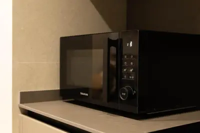 a microwave oven sitting on top of a counter at Dorm4You Centro in Valencia