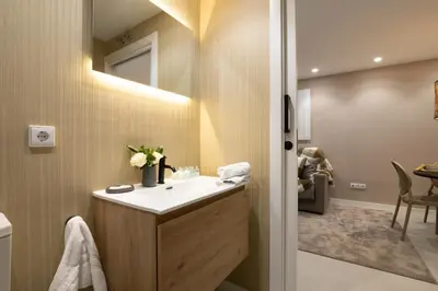 a bathroom with a sink and a mirror at Dorm4You Centro in Valencia