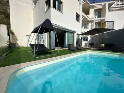 a swimming pool with a gazebo next to a building at Beautiful villa spectacular sea view in Faro de Cullera