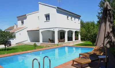 a villa with a swimming pool in front of a house at Gran Chalet con Piscina (8-10 pp) in La Eliana