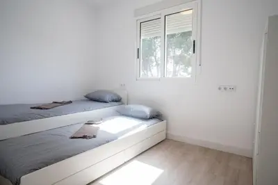 a bedroom with two beds and a window at Gran Chalet con Piscina (8-10 pp) in La Eliana