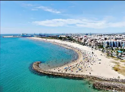 an aerial view of a beach with umbrellas and the ocean at Ca Vicent in Estivella