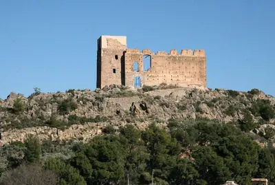 a castle on top of a hill with trees at Ca Vicent in Estivella