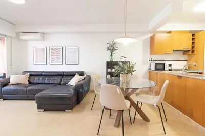 a living room with a couch and a table at Global Vacacional, Apartamento con piscina y terraza en la playa de Canet in Canet de Berenguer