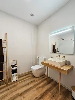 a bathroom with a toilet and a sink and a mirror at Pivote Flats - Marina B in Valencia