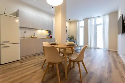 a kitchen and dining room with a table and chairs at Pivote Flats - Marina B in Valencia