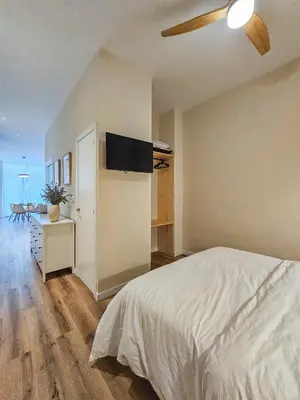 a bedroom with a bed and a flat screen tv at Pivote Flats - Marina A in Valencia