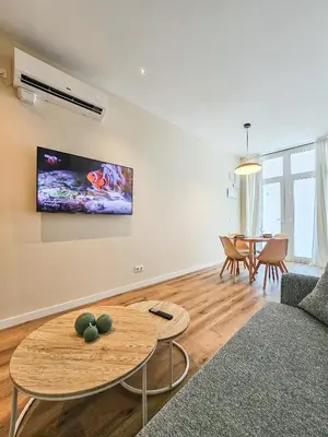 a living room with a couch and a table at Pivote Flats - Marina A in Valencia