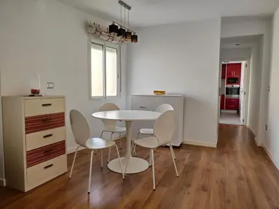 a kitchen and dining room with a table and chairs at Piso cerca universidades y playa in Valencia