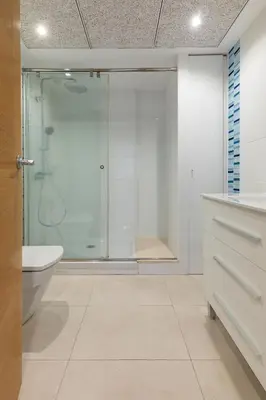 a bathroom with a glass shower and a toilet at ApartUP Patacona Paradise Duplex in Valencia