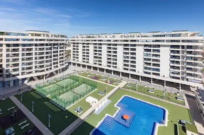an aerial view of a large apartment building with a pool at ApartUP Patacona Paradise Duplex in Valencia