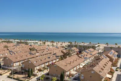 an aerial view of a resort with the beach at ApartUP Patacona Paradise Duplex in Valencia