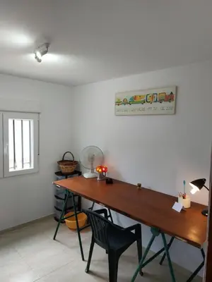 a room with a wooden table and a desk at les berreries in Montroy