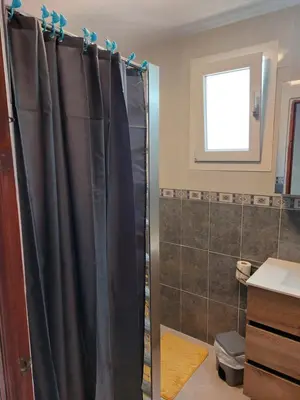 a bathroom with a shower with a shower curtain at les berreries in Montroy