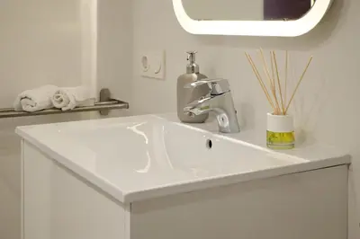 a white sink in a bathroom with a mirror at Apartamento de diseño en la Plaza del Carmen F1 in Valencia